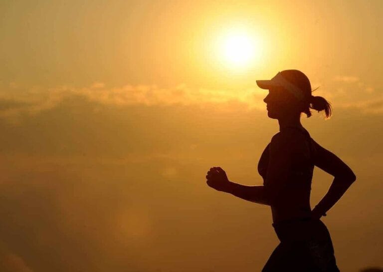 Silhouette of a woman running at sunrise, fitness, wellness, healthy lifestyle, Consilium Asset Management.