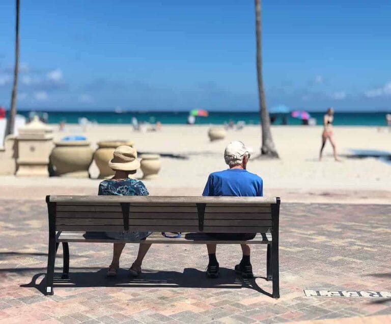 Relaxing seniors enjoying beach view in sunny Miami.
